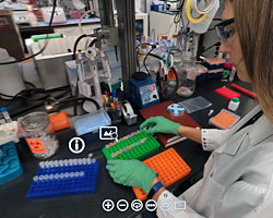 Image showing a lab reasearchers working at a bench with various lab tools in view.