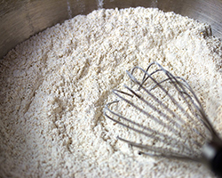 Flour in a bowl with a whisk ready for mixing