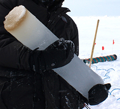 Researcher holding a piece of ice core.