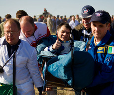 Astronaut getting carried after returning to Earth