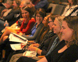Adults laughing in an auditorium
