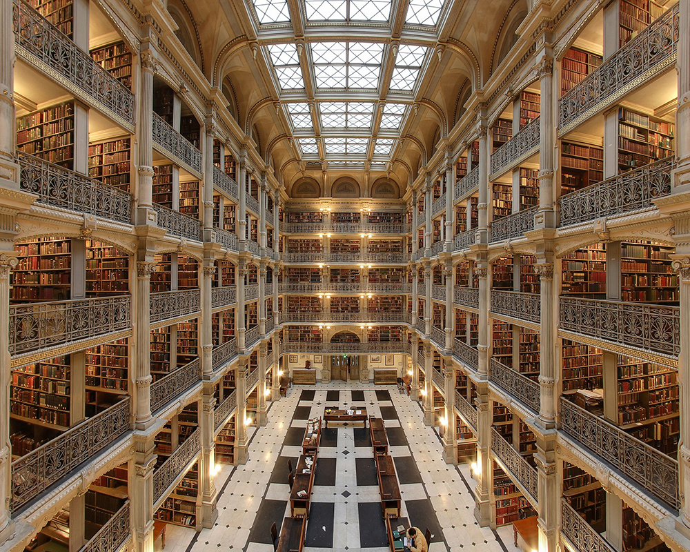 a palace-like library, the George peabody library, with multiple floors and beautiful architecture and windows