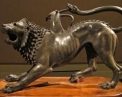 A black statue with the head of a lion, wings, and a tail; a Greek chimera.