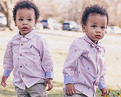 Two twin boys wearing matching outfits