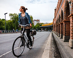 A woman riding her bike down an empty city street