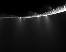 Pictures of the plumes of material coming off of the surface of Enceladus, one of Saturn's moons.