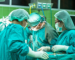 A picture of four medical professionals doing surgery