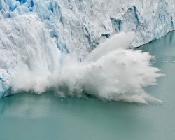 part of a glacier falls into the ocean