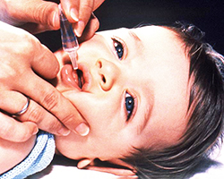 Child receiving oral polio vaccine