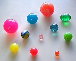 An assortment of bouncy balls in a variety of sizes and colors