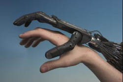 A robot hand hovering over a human hand