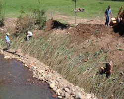 Environmental engineers modifying a river.