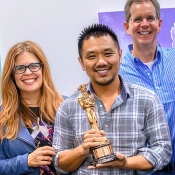 John Truong holding Oscar award from the movie Frozen the 2014 Best Animated Feature Film of the Year