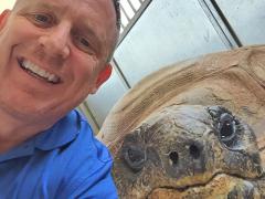 Dr. Gary West with Ali the Aldabra tortoise.