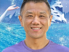 John Truong - artist, animator, and ant keeper. In front of a Frozen poster.