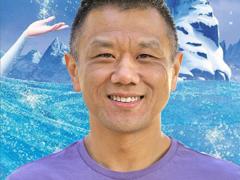 John Truong - artist, animator, and ant keeper. In front of a Frozen poster.