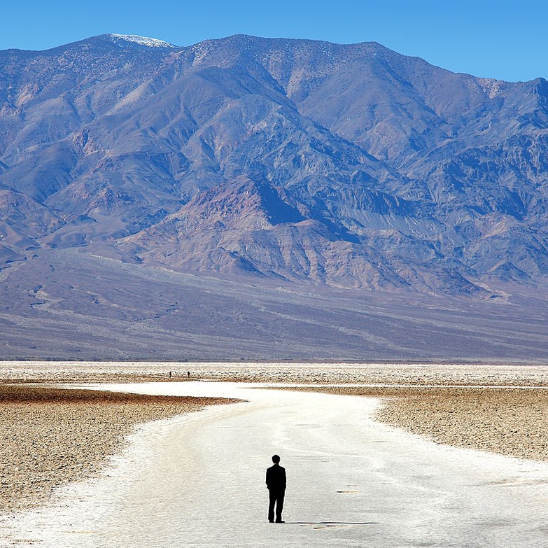 A person standing before desert flats in Death Valley