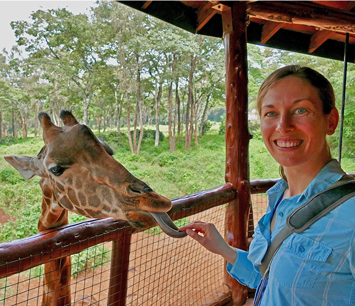 Biologist Elizabeth Pringle with a giraffe