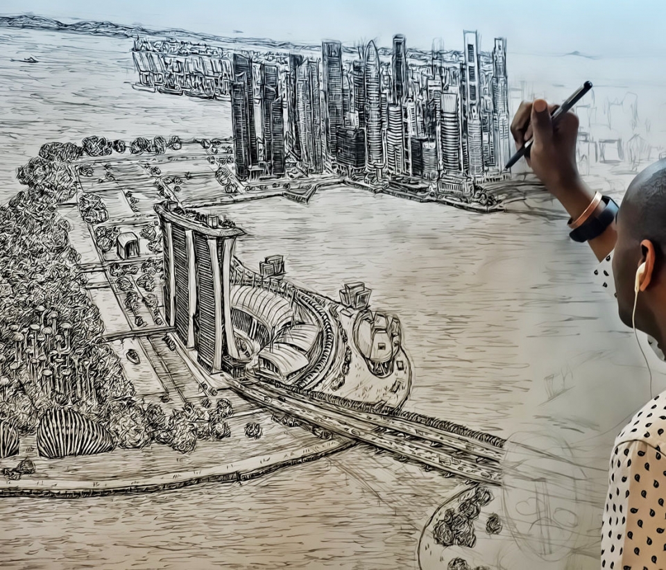 A view from behind of a man drawing an intricate cityscape in black and white