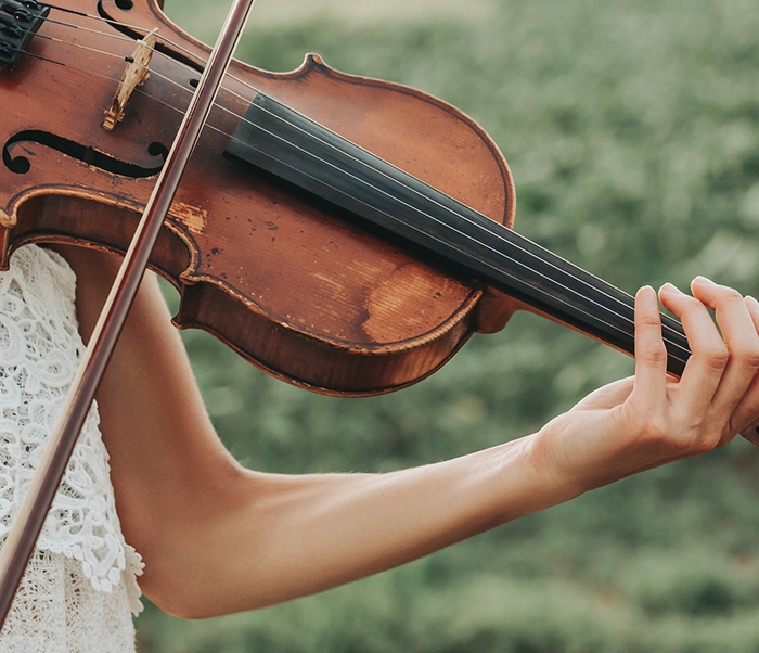 A close-up of someone playing a violin.