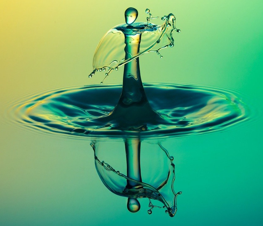 A splash of water with a yellow green reflection